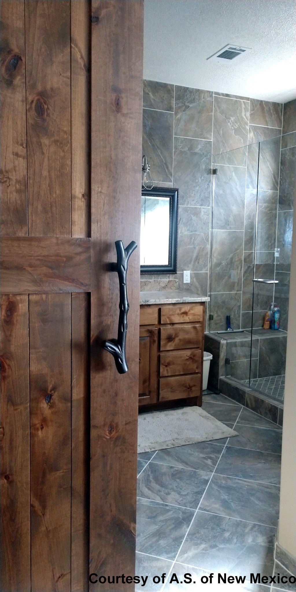 Tree branch handle pull for barn doors, 13-1/2 inches, shown on a wooden door in a bathroom setting.