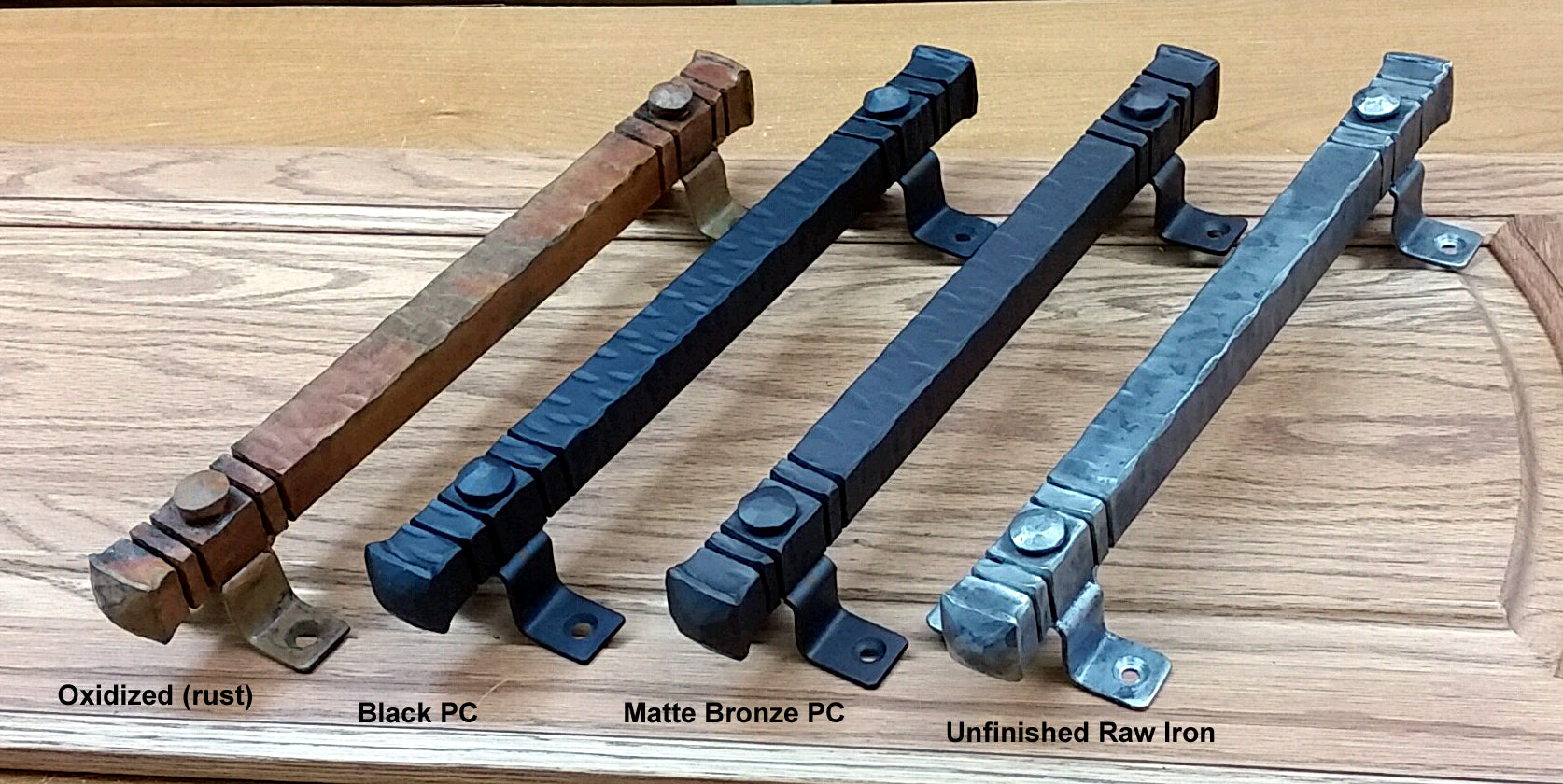 Jumbo 14-inch bridge door pull handles in oxidized, black, matte bronze, and unfinished raw iron finishes.