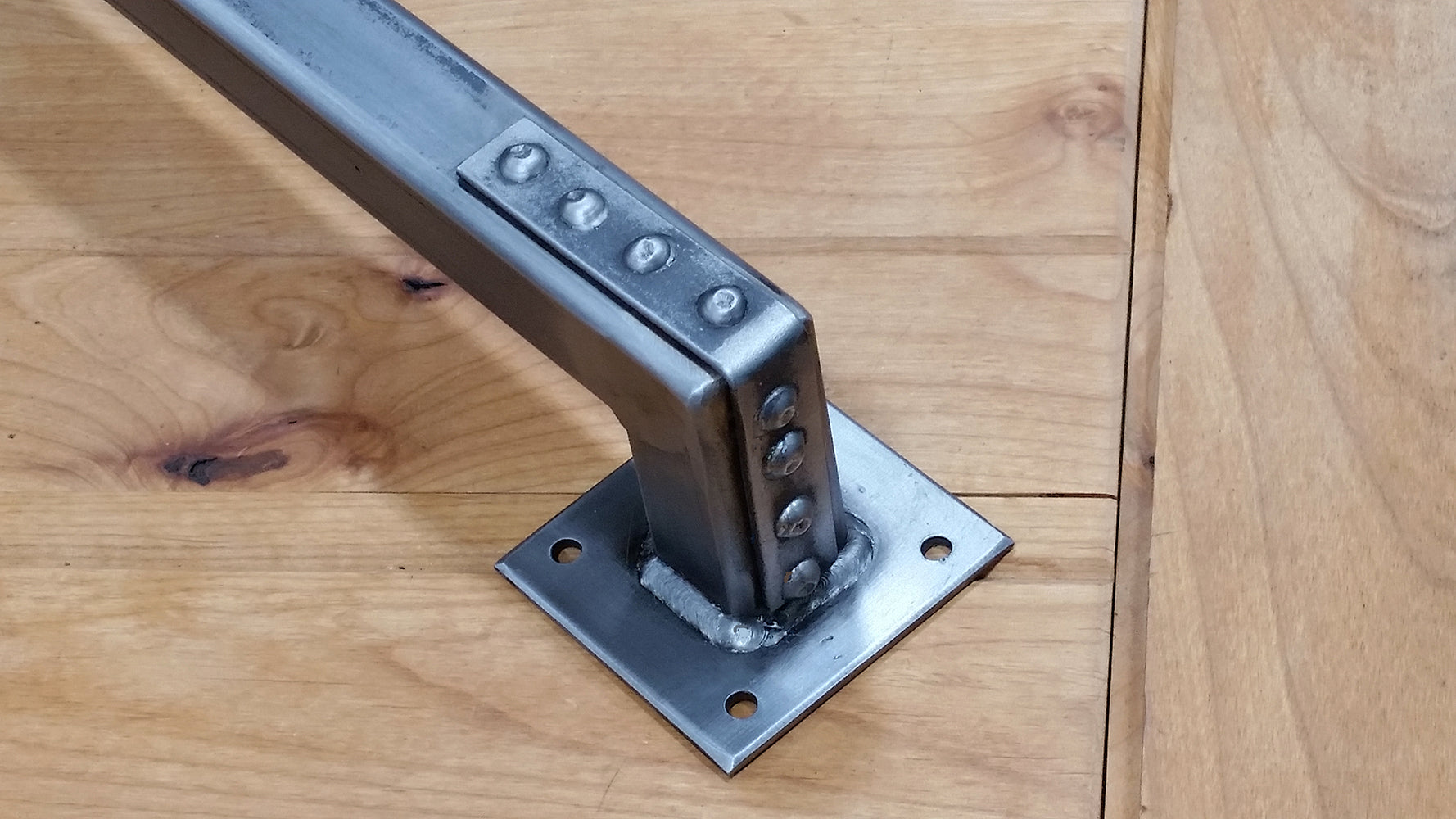 Industrial-style barn door handle pull with studded bracket ends, 24 inches, available in multiple finishes.