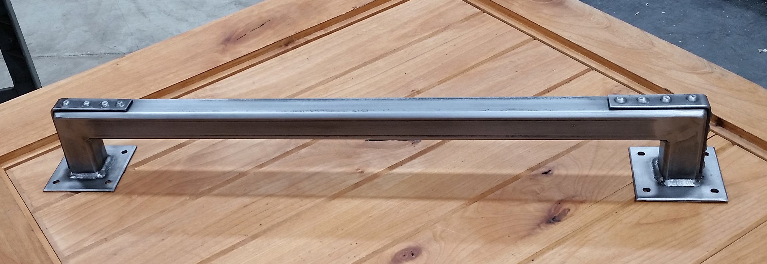 Industrial-style barn door handle pull with studded bracket ends, 24 inches, available in multiple finishes.