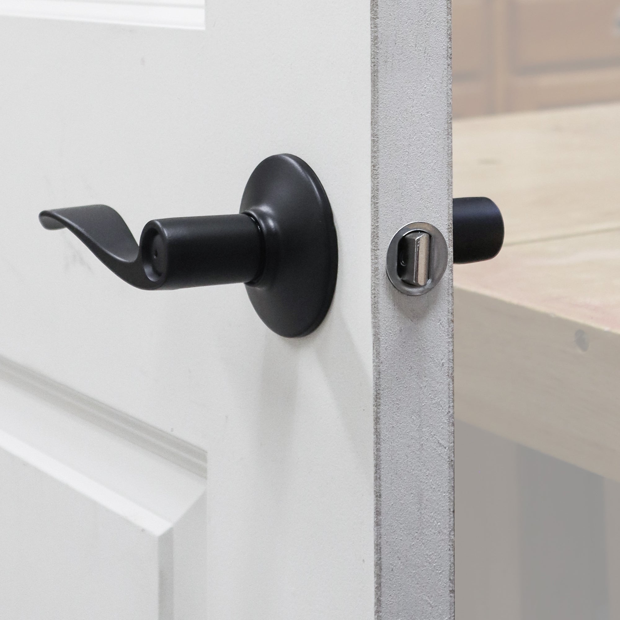 LockMate installation jig set for easy and precise door lock installation, featuring a sleek black handle and keyhole.