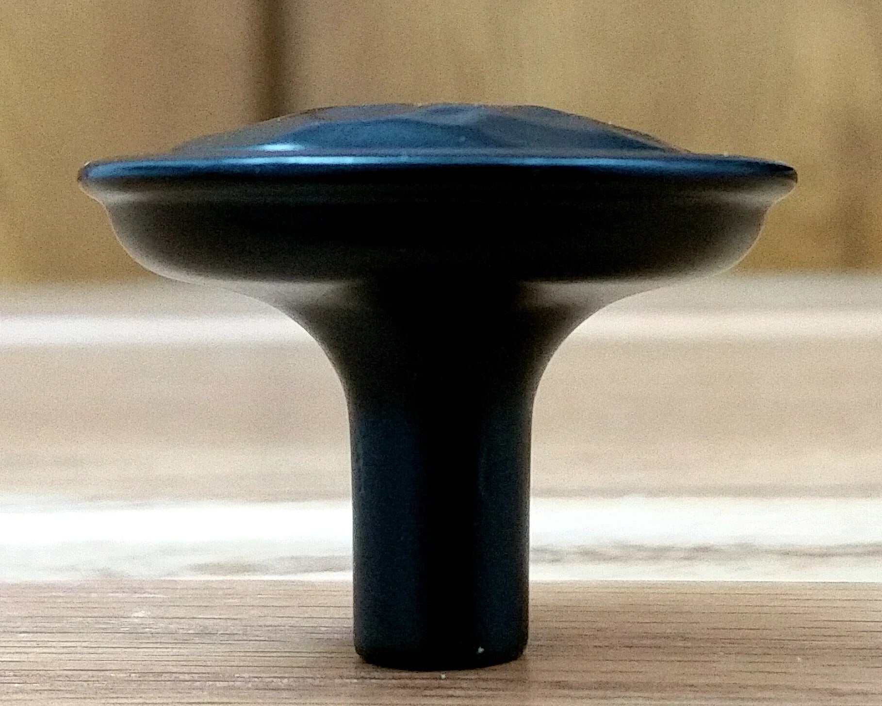 Rustic hammered knob in oil rubbed bronze finish, featuring a textured surface and sturdy design for cabinets.