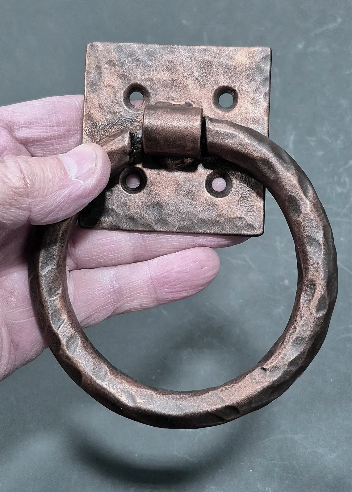 Distressed 4-inch ring pull with hammered back plate, available in multiple finishes, sold individually.