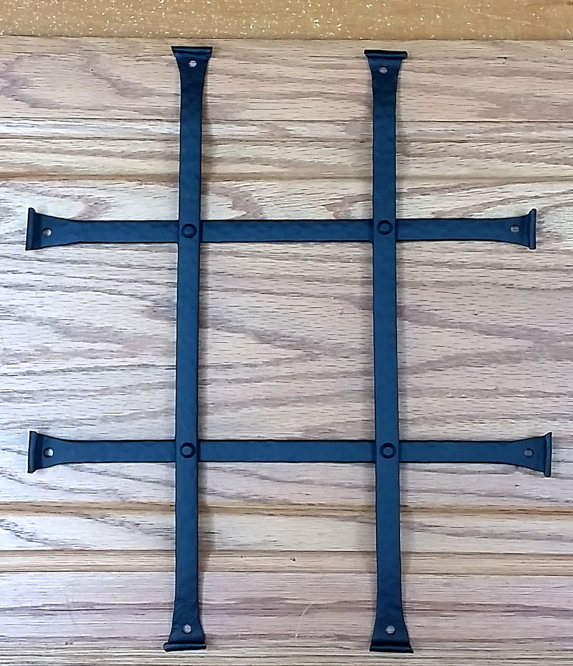 Low profile black powder-coated door and gate grille with four bars, measuring 10 by 12 inches, sold individually.