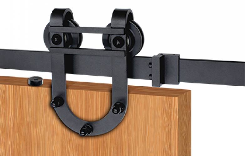 Matte black barn door hardware kit featuring surface mount horseshoe hinges and soft close option for wood doors.