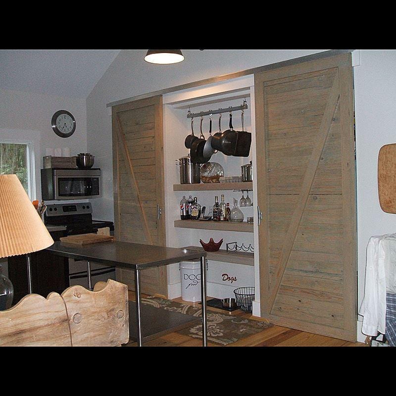 Modern aluminum barn door hardware with a 60-inch track, designed for 30-inch doors, enhancing interior spaces.