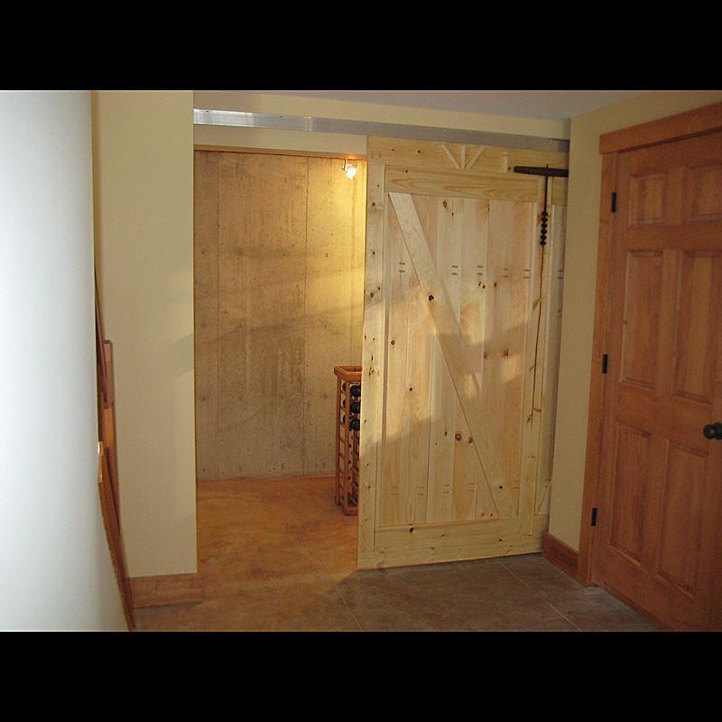 Modern aluminum barn door hardware with a 72-inch track designed for 36-inch doors, enhancing interior spaces.