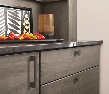 Versa Series cabinet knobs in 1-3/8 inch size, available in multiple finishes, enhancing modern cabinetry.