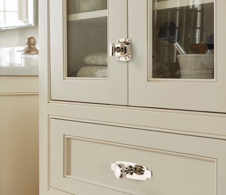 Highland Ridge Series cabinet latches in various finishes, 1-7/8 inches, displayed on a stylish kitchen cabinet.