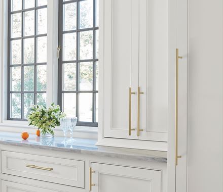 Stylish golden champagne cabinet pulls in bar pull design, 7-9/16" center to center, enhancing modern kitchen decor.