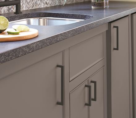 Matte black cabinet pulls from the Monument Series, 5-1/16" center to center, enhance modern kitchen design.
