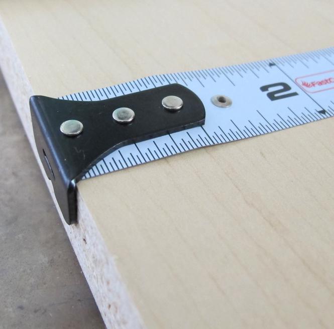 Procarpenter Flatback Flexible Tape Measure resting on a wooden surface, showing clear measurement markings.