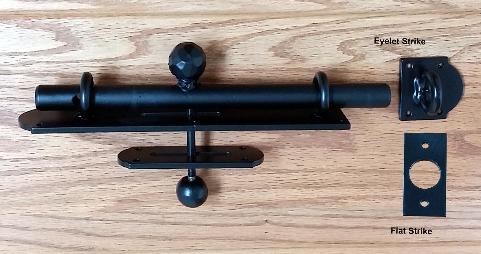Heavy duty rustic slide bolt for gates and doors, dual side operation, black powder coat finish, includes eyelet and flat strike.