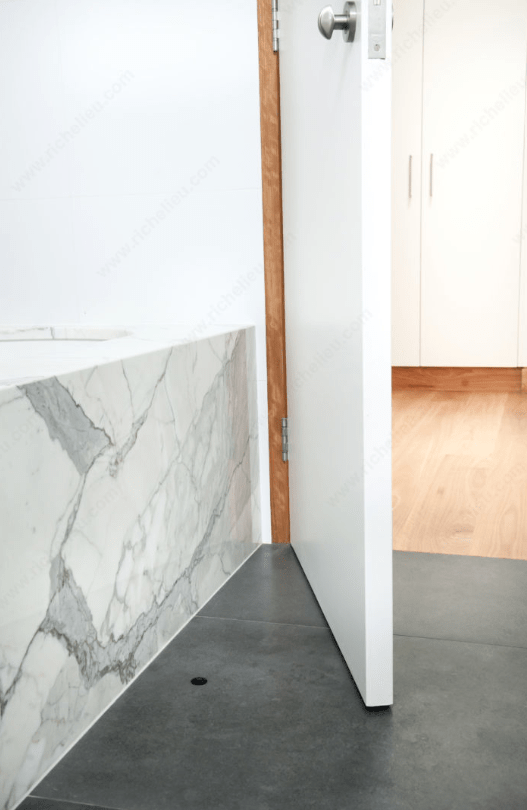 Hidden magnetic door stop in a sleek design, installed on a modern floor, ideal for maintaining open doors.