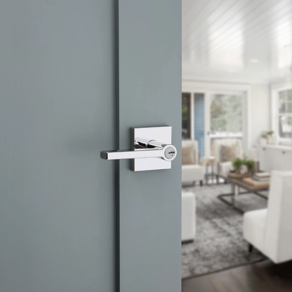 Kwikset Halifax square door lever entry lock in bright polished chrome finish, featuring SmartKey security, installed on a door.