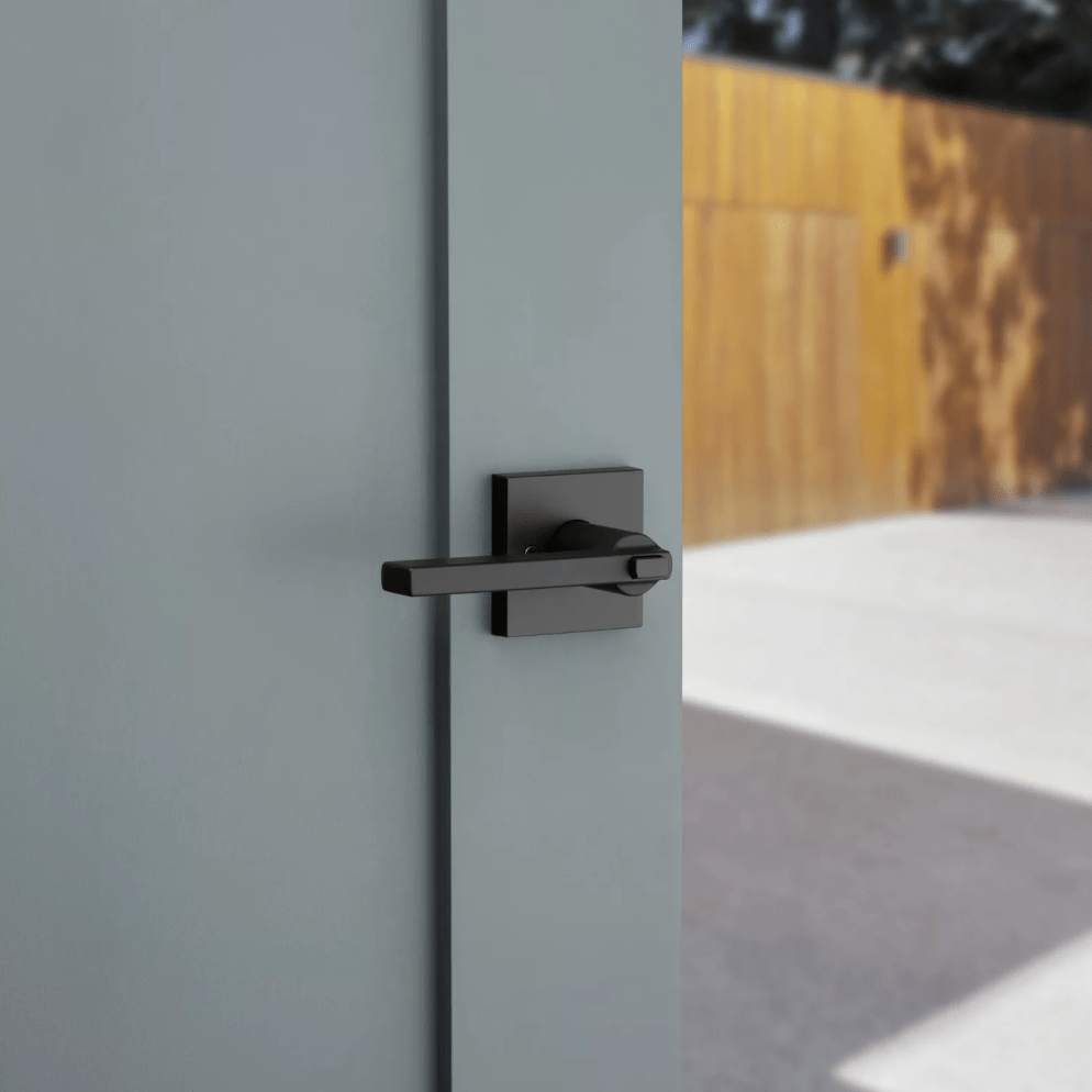 Kwikset Halifax square design entry door lever in iron black finish with SmartKey security, ideal for residential use.