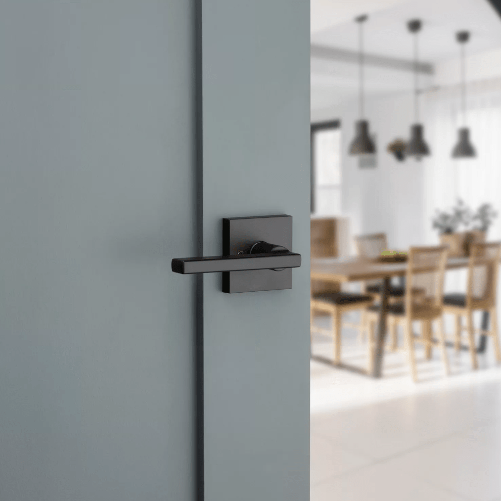 Kwikset Halifax square non-locking passage door lever in iron black finish, ideal for residential use.