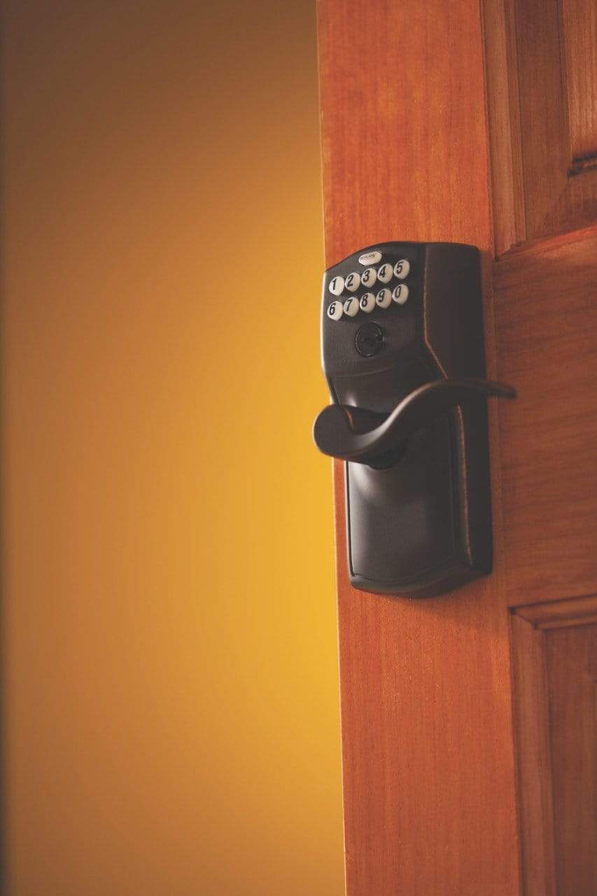 Schlage electronic keypad lockset with accent lever and Camelot trim in aged bronze finish for residential doors.