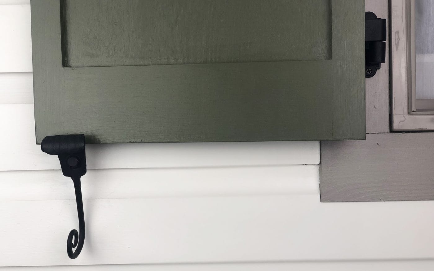 Black forged steel shutter dogs with a powder coat finish, designed for securing shutters, sold in pairs.