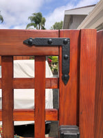 Hand-forged rustic hammered brackets and braces, ideal for enhancing wooden gates and fences with a vintage look.