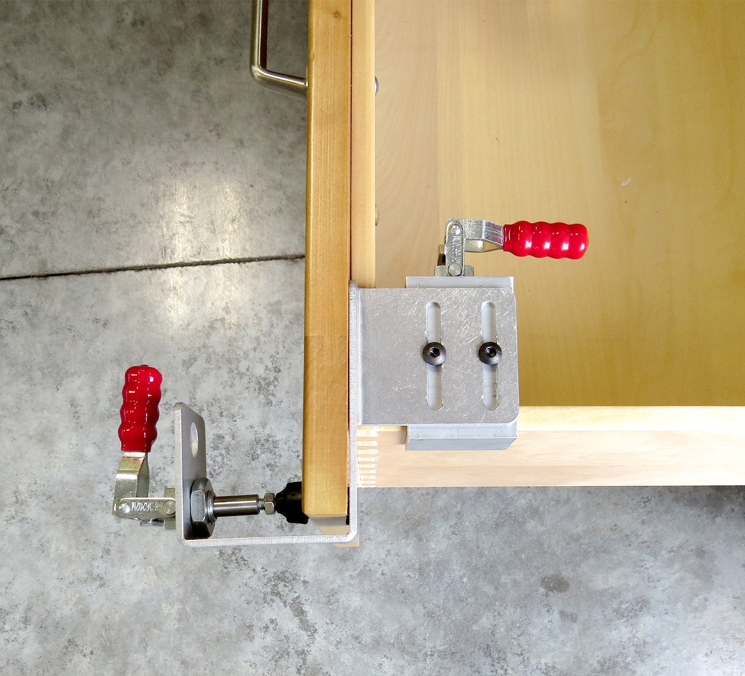 Drawer front clamps sold in pairs, securely holding a drawer front in place for easy assembly and alignment.