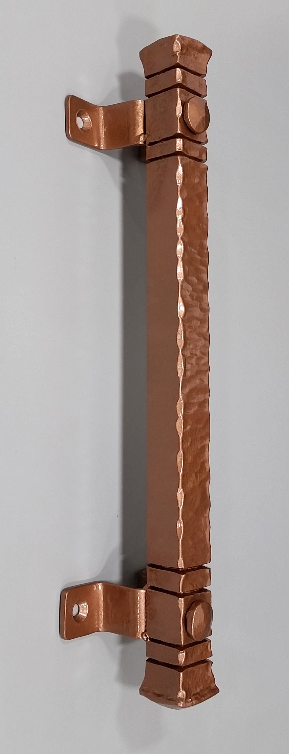 Jumbo 14-inch bridge door pull handle with a hammered finish and decorative accents, available in multiple finishes.