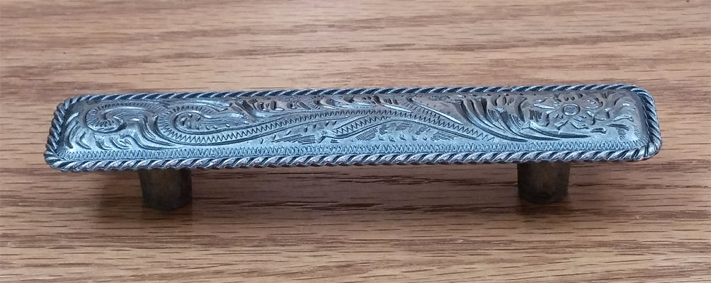 Engraved drawer pull with rope edge design in old silver finish, sold individually for cabinets or furniture.