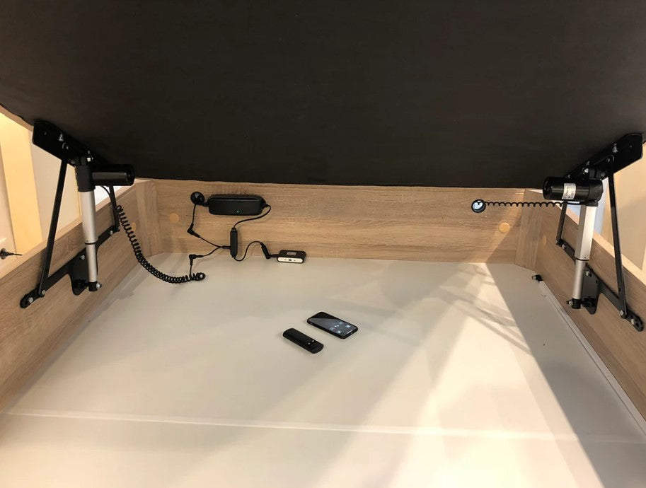 Hydraulic lift motorized storage bed mechanism kit showing interior with storage space and electronic components.