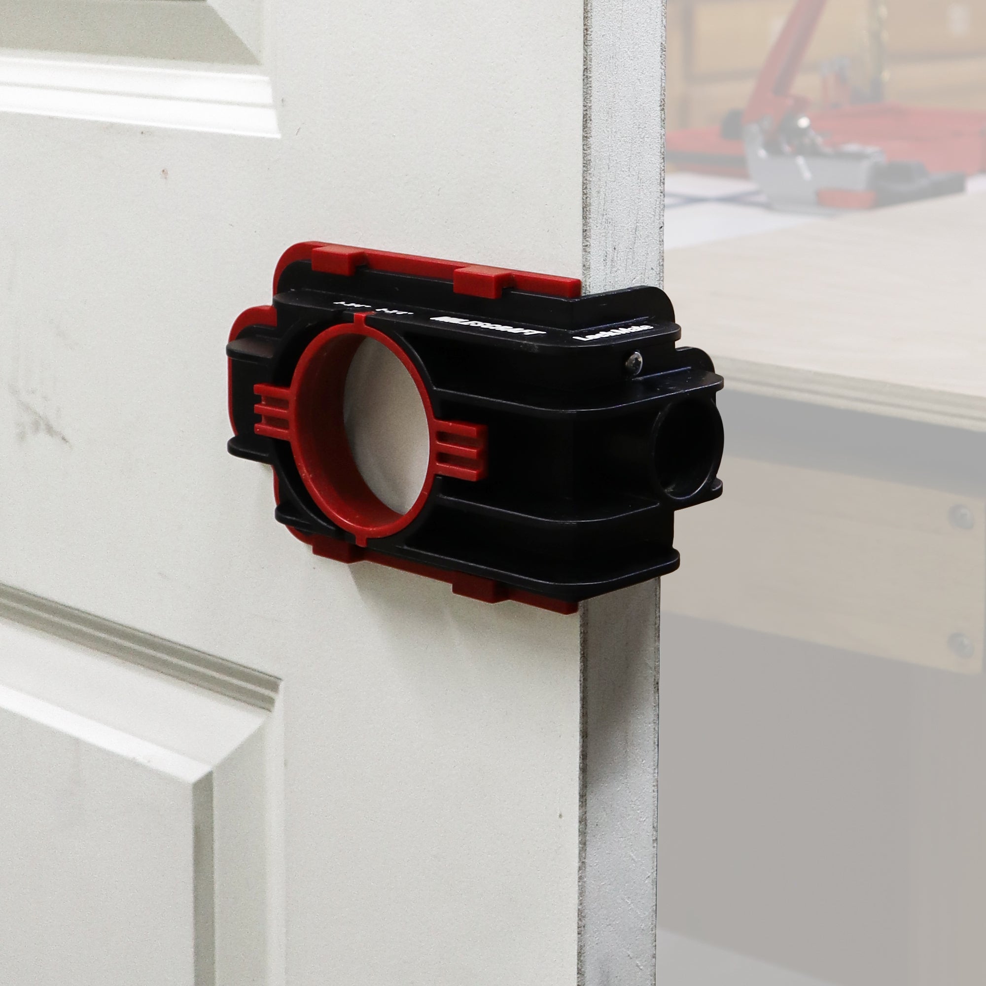 LockMate installation jig securely attaches to a door for precise lock installation, featuring a durable design.