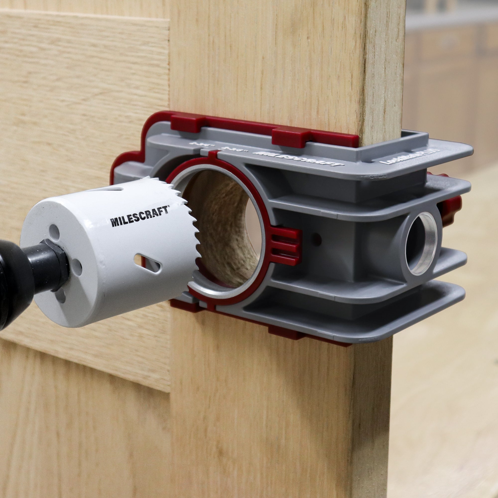 Self-clamping installation jig for locks and knobs, designed for professional use, securely mounted on a door.