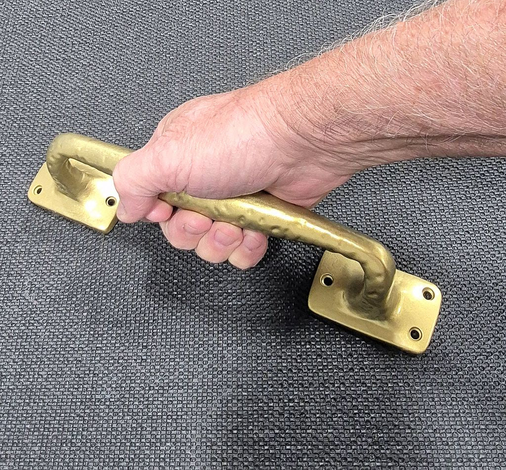 Old World style door pull appliance pull held in hand, featuring a textured finish and available in multiple colors.