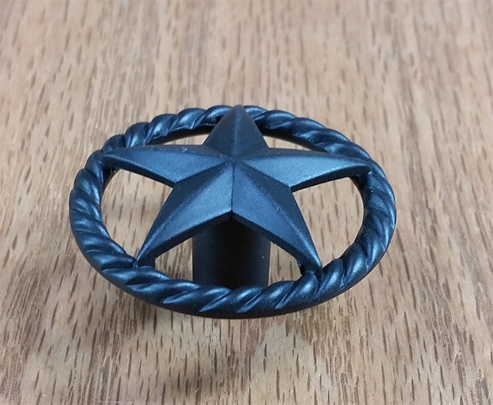 Single star knob with a rope edge design in an oil rubbed bronze finish, ideal for cabinets and furniture.