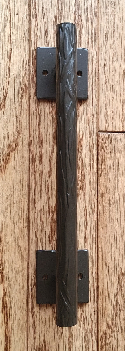 Tree branch door pull with a textured design, 12 inches long, includes two mount plates, available in multiple finishes.