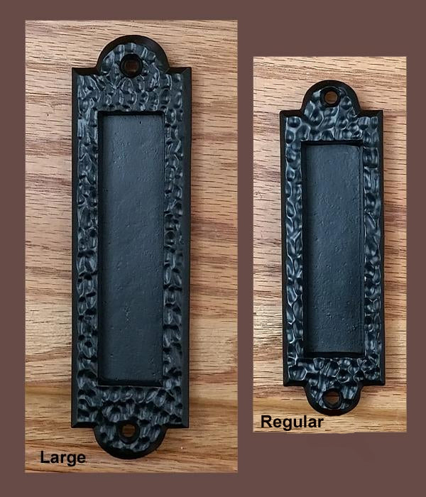 Flush pull barn door handle with a distressed black finish, available in large and regular sizes, sold individually.