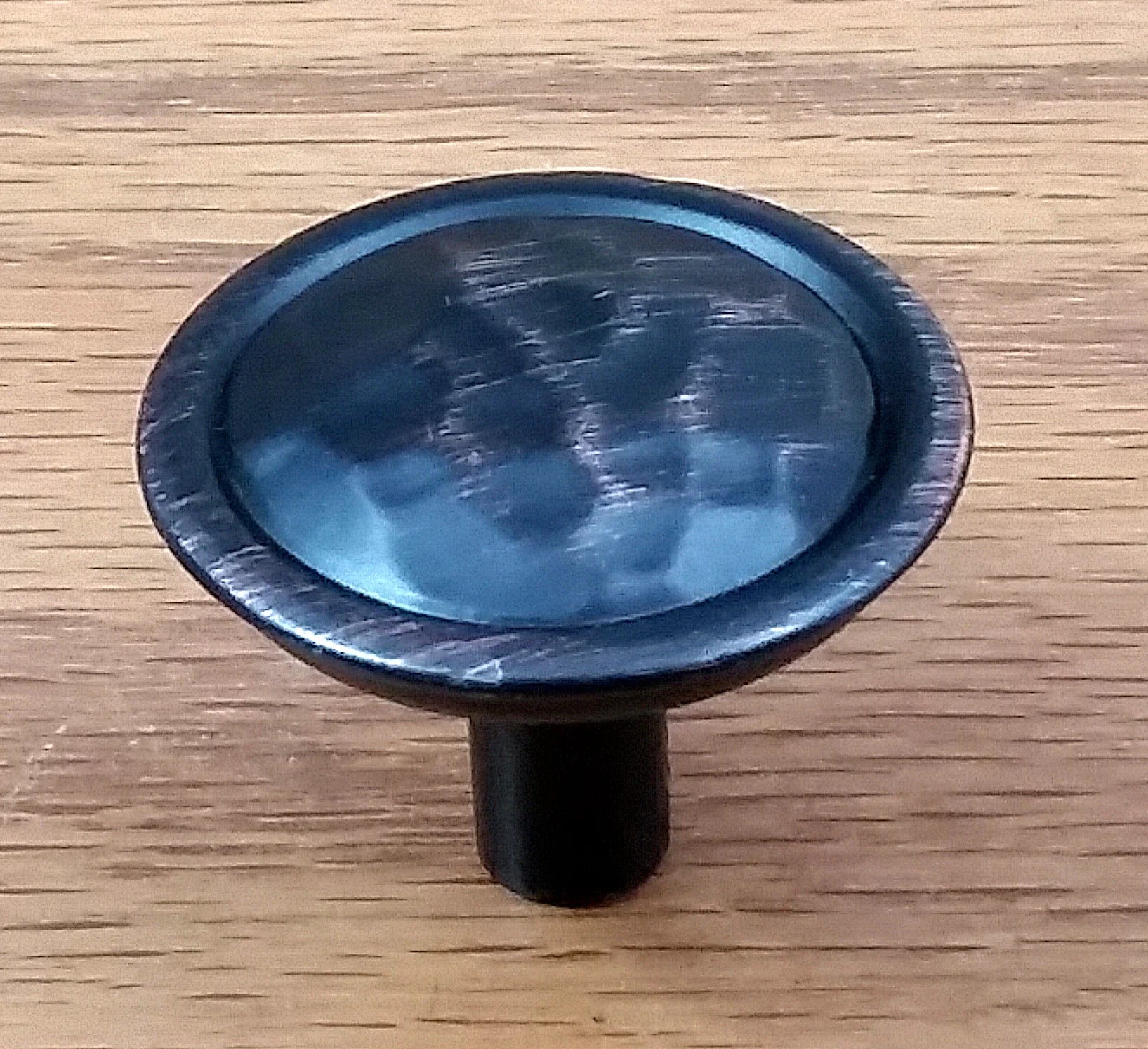 Rustic hammered knob in oil rubbed bronze finish, perfect for enhancing cabinets and furniture with a vintage touch.