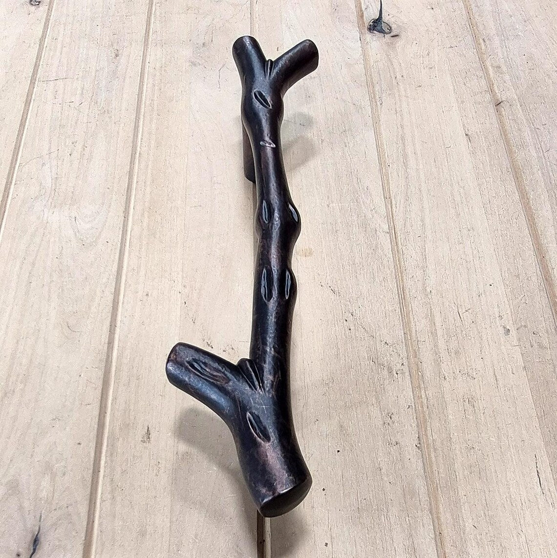 Tree branch handle pull designed for barn doors, 13-1/2 inches long, available in multiple finishes, sold individually.