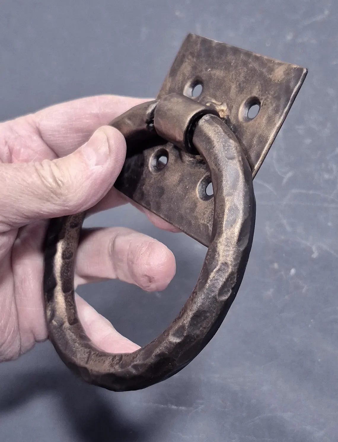 Distressed 4-inch ring pull with hammered back plate, available in multiple finishes, sold individually.