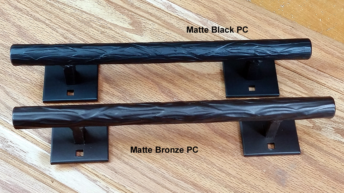 Tree branch door pull in matte black and matte bronze finishes, 12 inches long with two mount plates included.