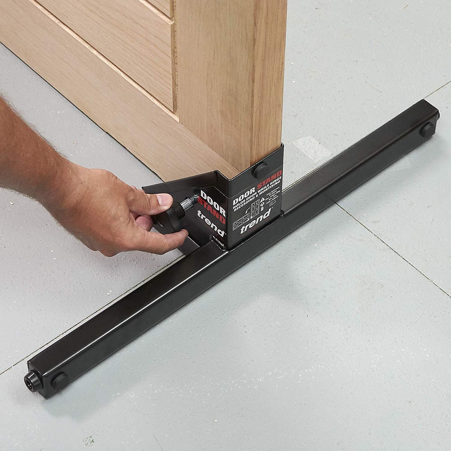 Door holder stand tool for precise door installation, featuring adjustable angles and a sturdy base for stability.