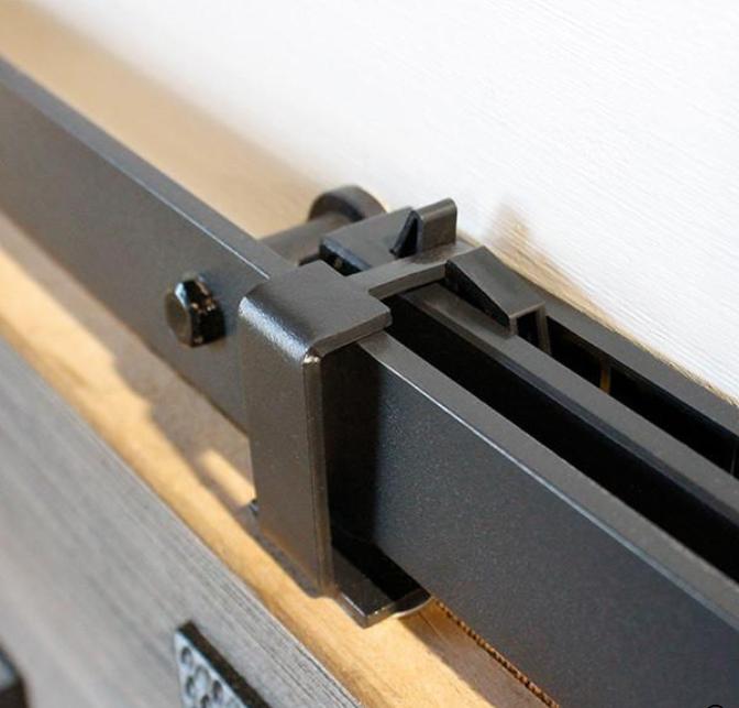 Barn door hardware kit featuring soft close mechanism in a sleek black finish for smooth operation and modern design.