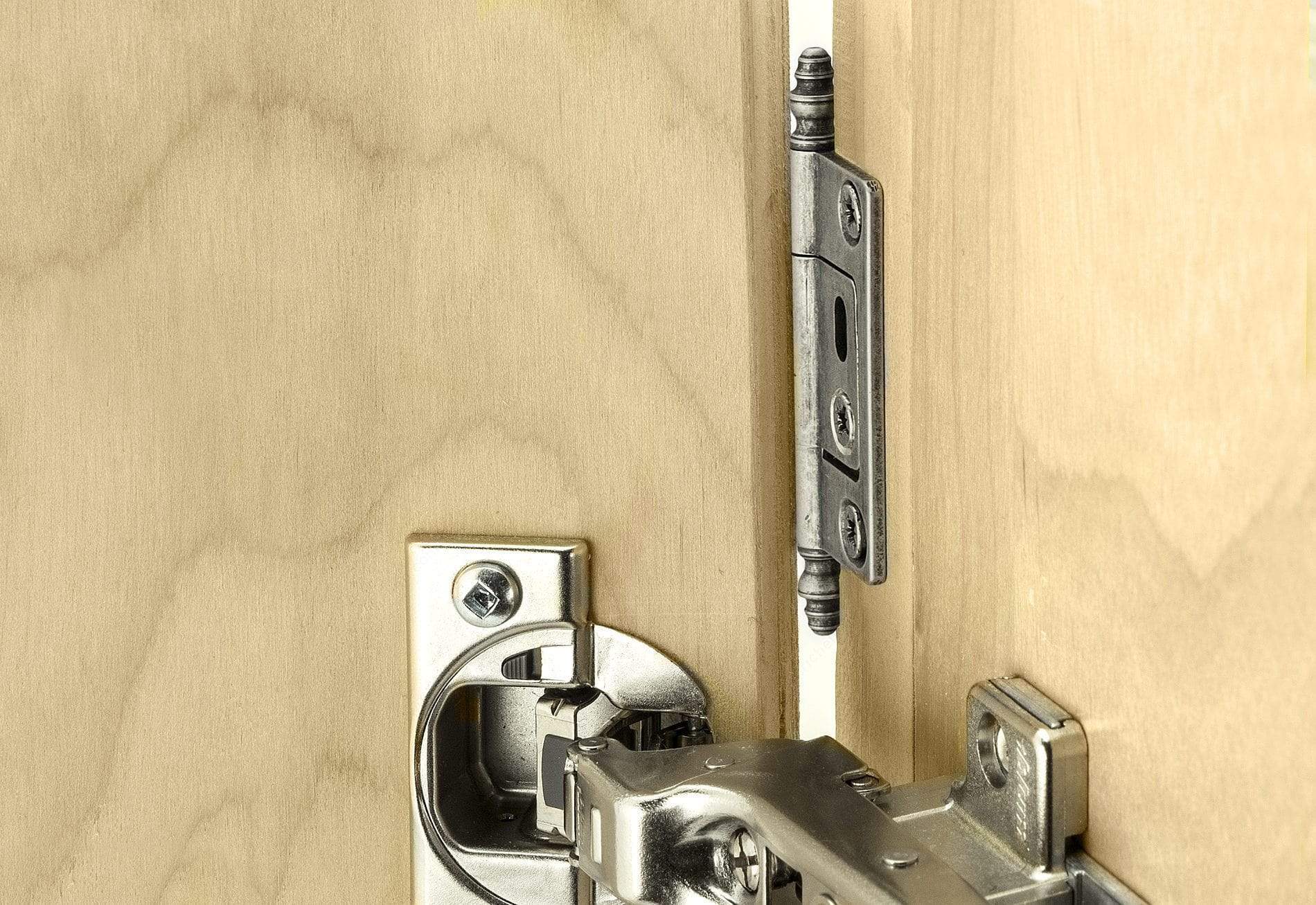 Classic brass bifold hinge installed on wooden doors, available in multiple finishes and sold individually.