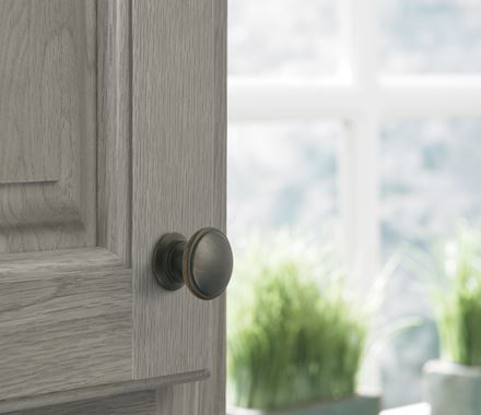 Oil rubbed bronze cabinet knob from the Ravino Series, 1-1/4 inch, enhancing modern cabinetry with elegance.