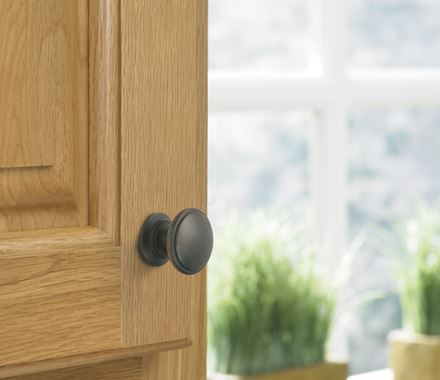 Oil rubbed bronze cabinet knob from the Ravino Series, 1-1/4 inch, designed for stylish home cabinetry.