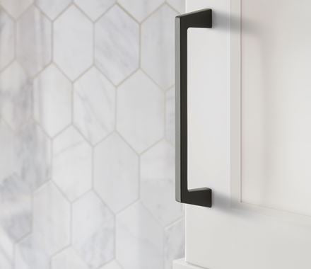 Blackrock Series cabinet pull in black finish, 6-5/16" center to center, mounted on a white cabinet.