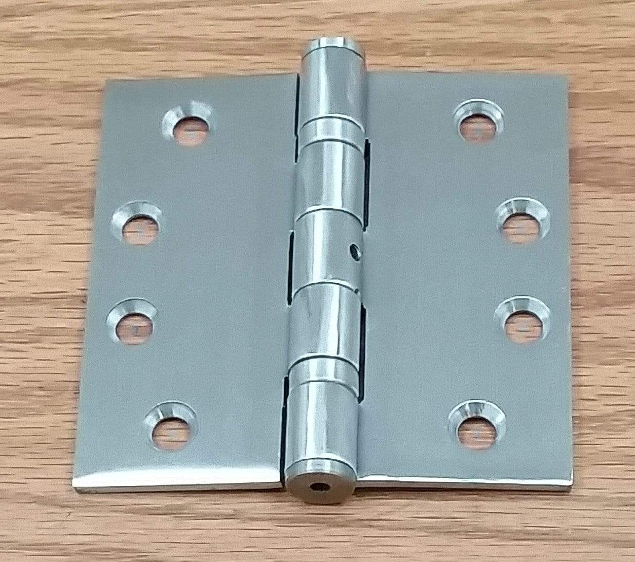 Commercial ball bearing door hinge, 4 inches square, available in multiple finishes, sold in pairs for durability.
