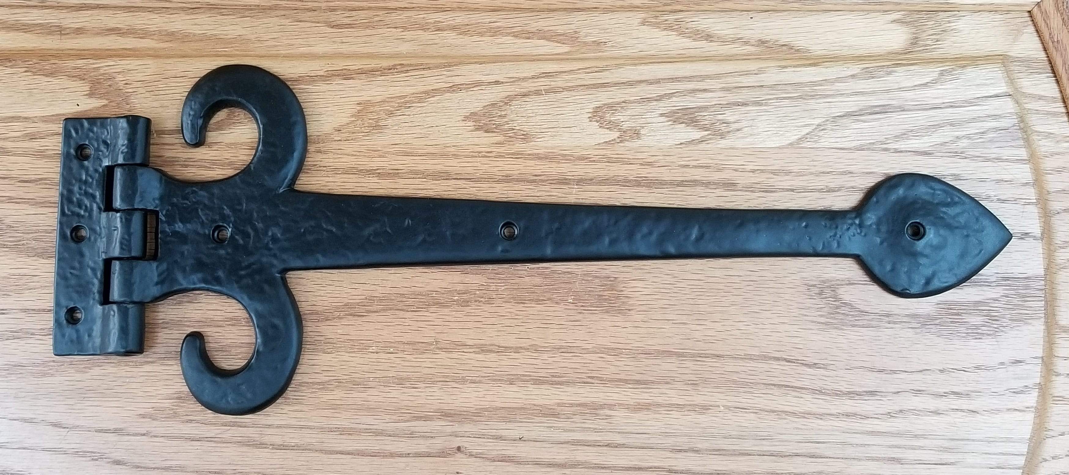 European black solid iron decorative strap hinge, 15 inches long, featuring an elegant design for doors or gates.