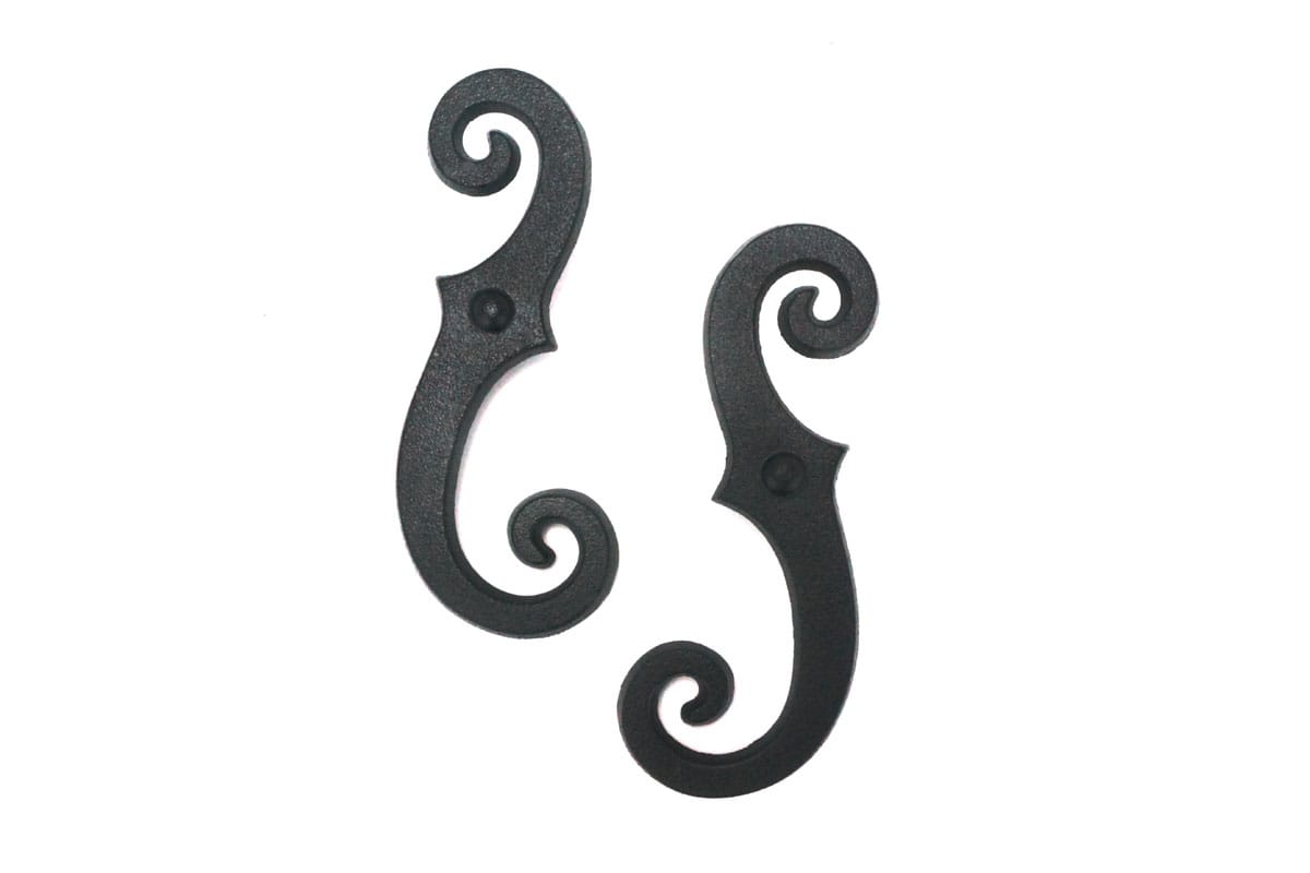 Black cast iron faux shutter dogs with a beveled smooth scroll design, measuring 6-3/4 inches, sold in pairs.