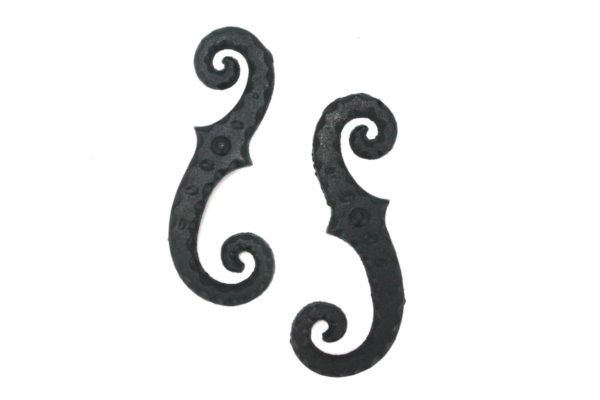 Faux shutter dogs tiebacks in black powder-coated cast iron, 6-3/4 inches, featuring a stippled scroll design, sold in pairs.