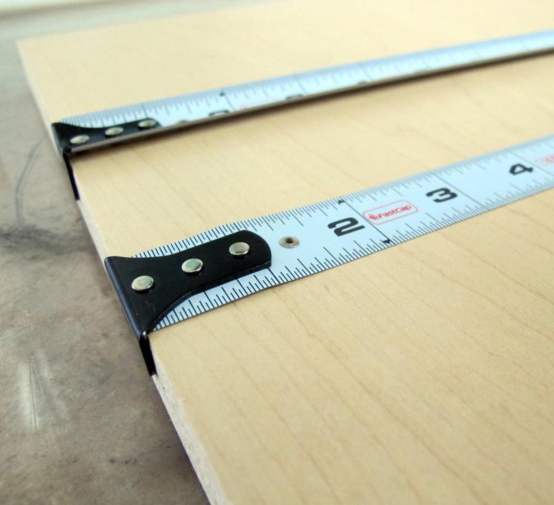 Procarpenter Flatback Flexible Tape Measure resting on a wooden surface, showcasing its measuring features.