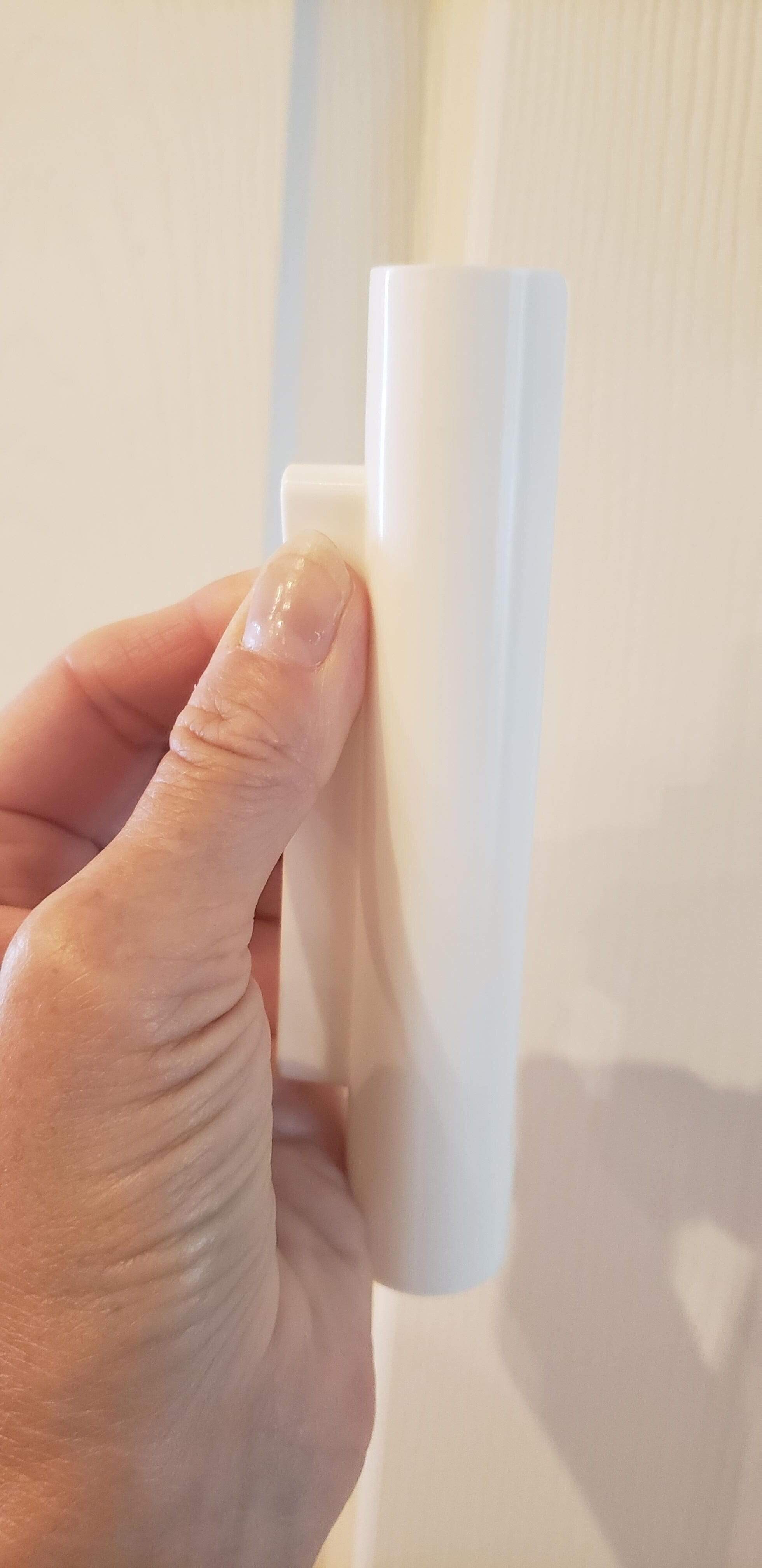 Hinge Hero door hinge lubrication tool held in hand, designed for easy application of lubricant to hinges.